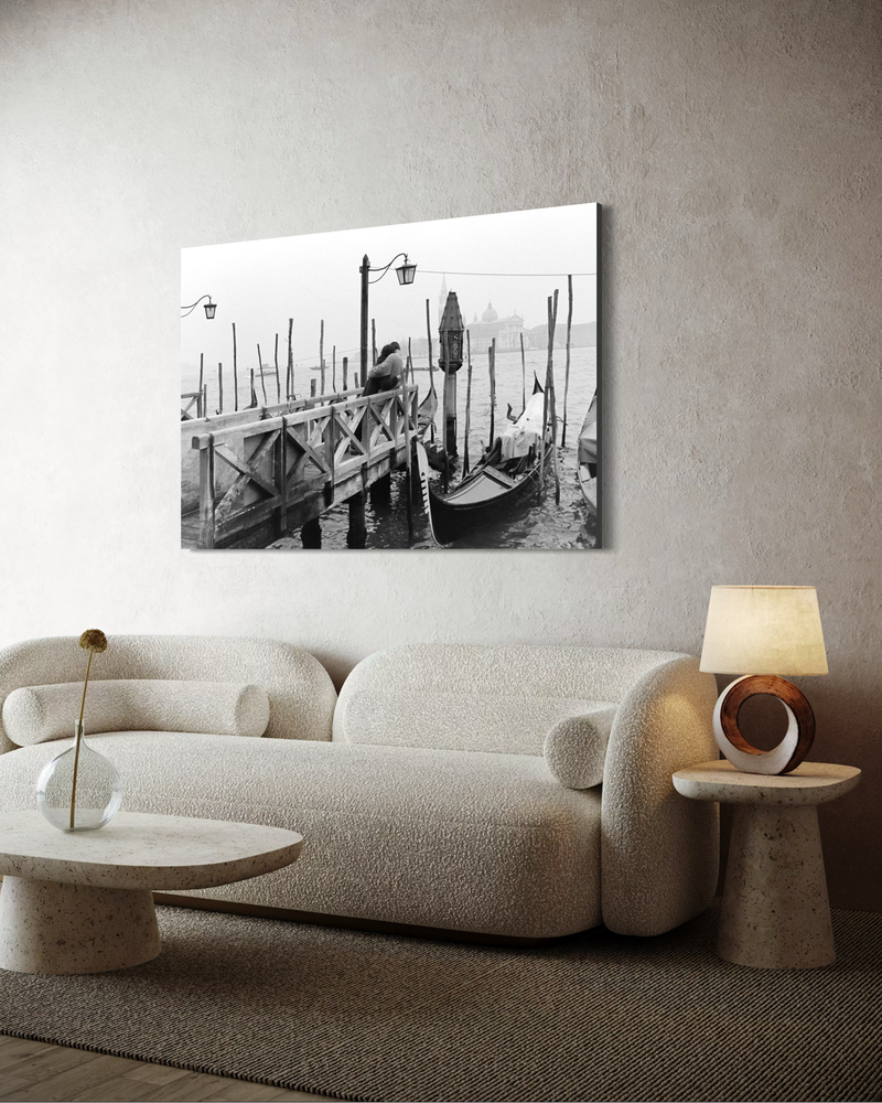 Black-and-white photography on canvas of a couple embracing on a pier in Venice, with gondolas, water, and a misty city backdrop.