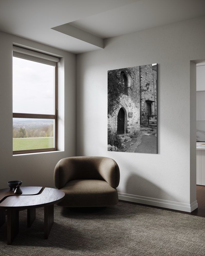 Black-and-white photography on canvas of an old stone building with an arched doorway and windows, capturing a quiet Italian street with historic character.