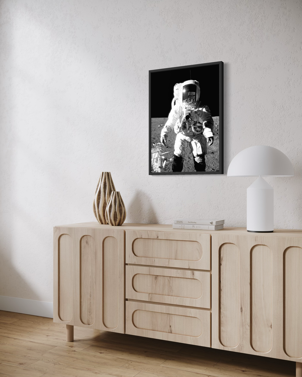 Photograph of astronaut Alan Bean on the lunar surface during Apollo 12, wearing a spacesuit and surrounded by moon terrain and equipment against deep black space.